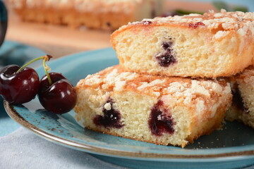 German cherry cake with vanilla and icing sugar, with glaze, served and sliced on plate