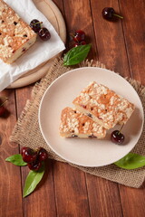 German cherry cake with vanilla and icing sugar, with glaze, served and sliced on plate