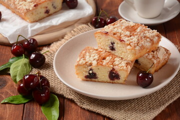 German cherry cake with vanilla and icing sugar, with glaze, served and sliced on plate