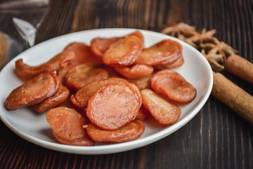Sausage Or Guan Chiang and Herbs on the board, serving good beer snacks on a dark background.
