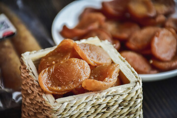 Sausage Or Guan Chiang and Herbs on the board, serving good beer snacks on a dark background.