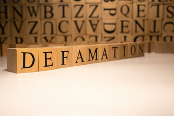 The word defamation end was created from wooden cubes. Countries and politics - obrazy, fototapety, plakaty