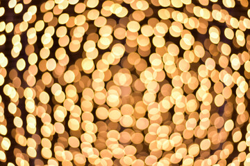 Abstract golden bokeh dark background.
