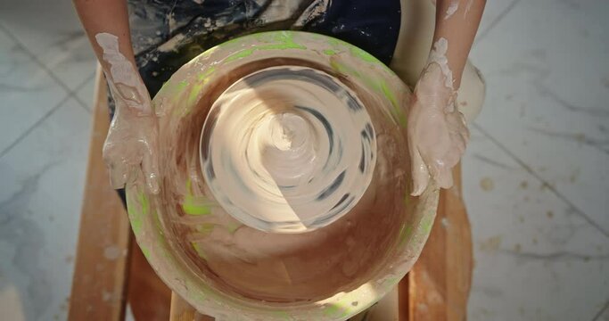 Potter's Wheel Pottery Spins A Frame From Above A Man Anonymously Creates A Product From Clay Roasting Eco-friendly Utensils In The Workshop