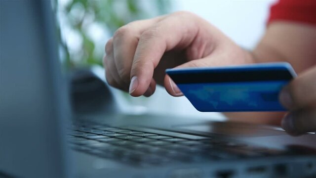 Buyer Makes Purchase On Internet And Points His Finger At CVV Code. Online Payment And  Shopping Concept.
