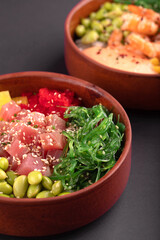 Two bowls of hawaiian poke mix with tuna fish and shrimp