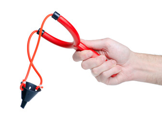 Fototapeta premium Red plastic slingshot in hand on white background isolationwhite background isolation