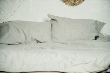 gray linens on the bed