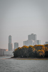 city skyline with the sea at sunset