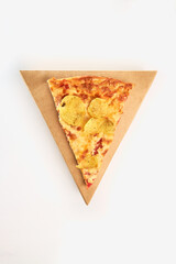 One slice of pizza with tomatoes, chips and cheese on a triangular cardboard box on a white background.