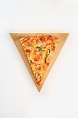 One slice of pizza with bacon, cucumbers and cheese on a triangular cardboard box on a white background.