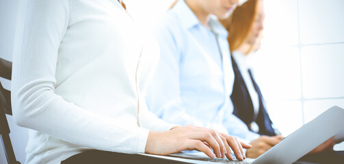 Group of business people working in office, close-up. Businesswoman working with laptop. Conference or training concepts