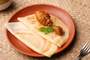 Dosa , Dosai, ghee roast with chicken curry popular South Indian Breakfast food, Kerala, Tamil Nadu India Sri Lanka. Masala dosa with non vegetarian Indian kadai chicken leg curry.