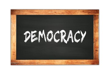 Obraz premium DEMOCRACY text written on wooden frame school blackboard.