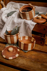 wooden pots of pepper, wooden box, white cloth, wooden table