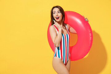 Happy fun young sexy woman slim body wear striped red blue one-piece swimsuit hold pink inflatable...