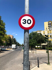 Traffic sign of maximum speed allowed for circulation on urban roads at 30 kilometers per hour,...