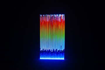 colorful light painting of vertical lines on black background
