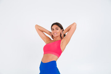 Fototapeta na wymiar Fit tanned sporty woman with abs, fitness curves, wearing top and blue leggings on white background