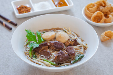 Noodle soup with braised pork and pork balls in bowl, Thai food style