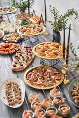 Delicious bruschetta with salmon and canape shrimp on table. Tasty buffet table. Summer party. Catering concept
