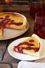 Creamy cherry pie. Wooden background, side view.