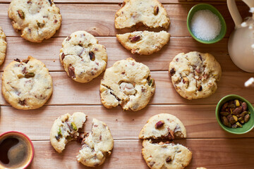 Cookies with caramel, pistachios and chocolate. Wooden background, top view