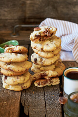 Cookies with caramel, pistachios and chocolate. Wooden background, side view
