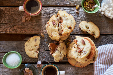 Cookies with caramel, pistachios and chocolate. Wooden background, top view