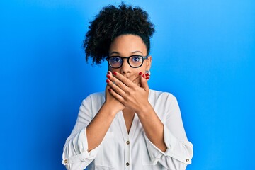 Fototapeta na wymiar Young african american girl wearing casual clothes and glasses shocked covering mouth with hands for mistake. secret concept.
