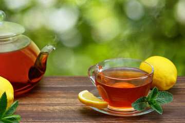 hot tea with lemon and mint in glass cup