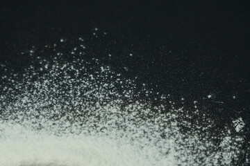 Flour on black background
