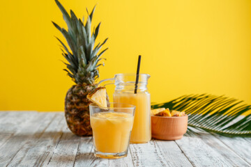Tasty pineapple juice in glass with ingredients. Fresh natural pineapple juice cocktail and...