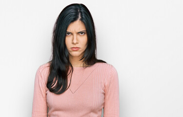 Fototapeta premium Young hispanic woman wearing casual clothes skeptic and nervous, frowning upset because of problem. negative person.