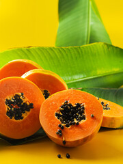 cut papaya on a leaf
