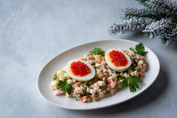 Olivier salad is a traditional Russian dish seasoned with mayonnaise, an essential attribute of the festive New Year's table and Christmas. Copy space.