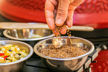 Chef prepares ingredients for bulgur on the grill. Close up