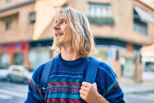 Young scandinavian student man smiling happy standing at the city.