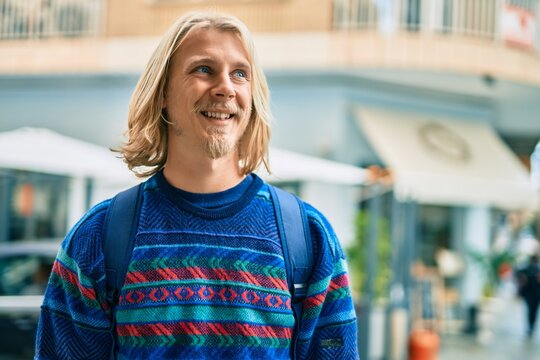 Young scandinavian student man smiling happy standing at the city.