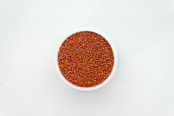 A sample of Camelina sativa seeds in a round test container. Raw materials for the manufacture of camelina oil. Oilseeds of agricultural crops. Top view of seeds.