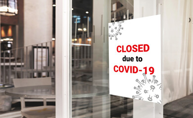 Posters announce in front of business offices or stores that have closed due to the impact of the spread of the novel coronavirus disease (COVID-19).