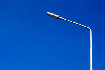Street lamp with led lighting against the blue sky. Horizontal image.