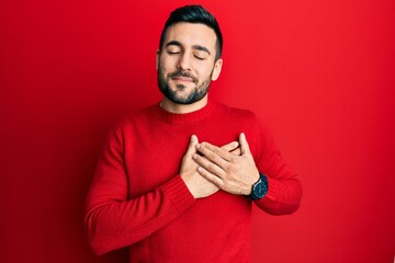 Young hispanic man wearing casual clothes smiling with hands on chest, eyes closed with grateful gesture on face. health concept.