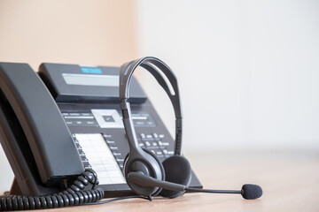 Obraz na płótnie Canvas Communication support, call center and customer service help desk. VOIP headset on telephone keyboard.