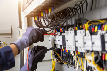 Electrician engineer tests electrical installations and wires on relay protection system....