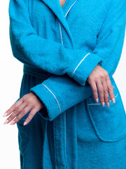 woman in a bright dressing gown advertises clothing details on an isolated white background.