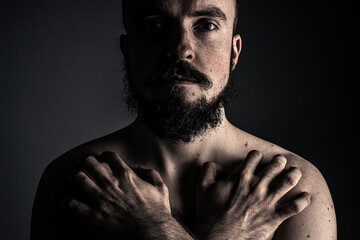 The man poses in a photo studio.