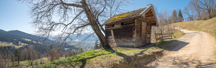 hiking trail upwards to sonntraten mountain near bad tolz, with wooden hut