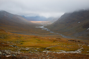 Fototapeta na wymiar The view of the valley in the direction of Sälka, hiking Kungsleden (king's) trail, rainy day, Lapland, Sweden, September 2020.