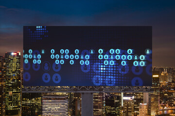 Glowing Social media icons on billboard over night panoramic city view of Singapore. The concept of networking and establishing new connections between people and businesses in Southeast Asia